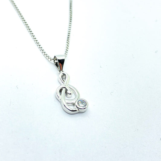 Collar de plata rodiada con colgante clave de sol con circonita para mujer